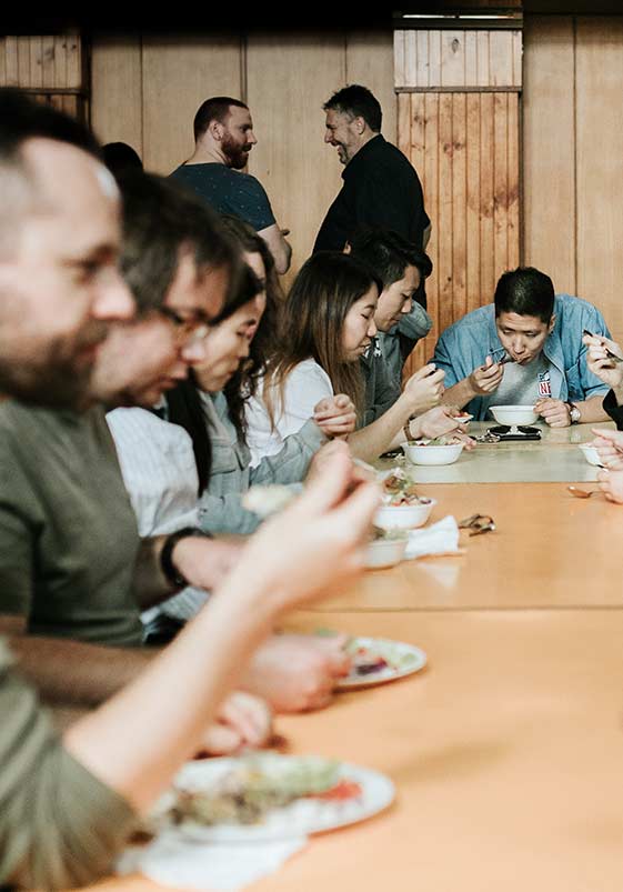 People gathered around long tables eating lunch at CityLight Church North Adelaide.